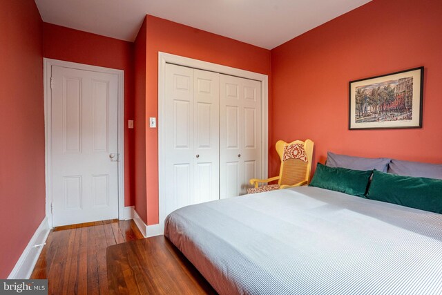 bedroom with wood-type flooring and a closet