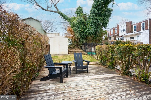 wooden deck with a storage shed