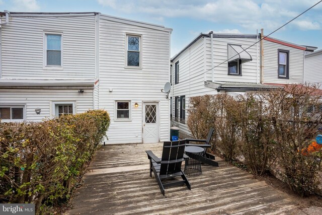 rear view of property with a wooden deck