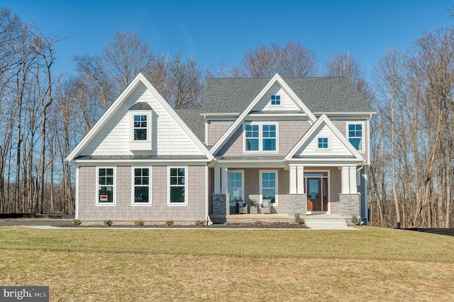 craftsman-style house with covered porch and a front lawn