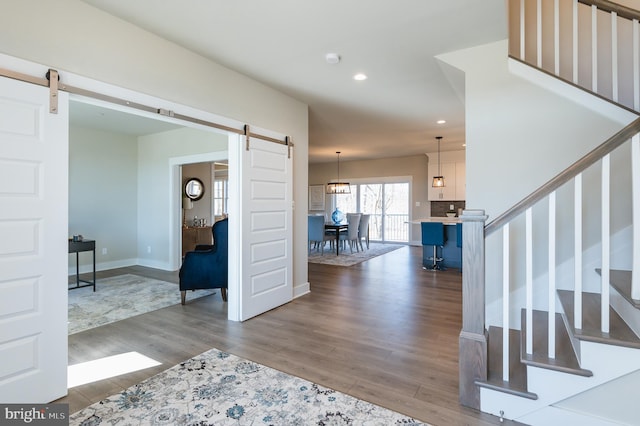 entryway featuring hardwood / wood-style flooring and a barn door