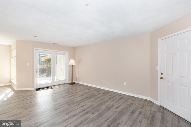 empty room with wood-type flooring