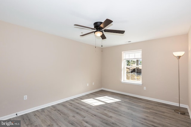 unfurnished room with hardwood / wood-style flooring and ceiling fan