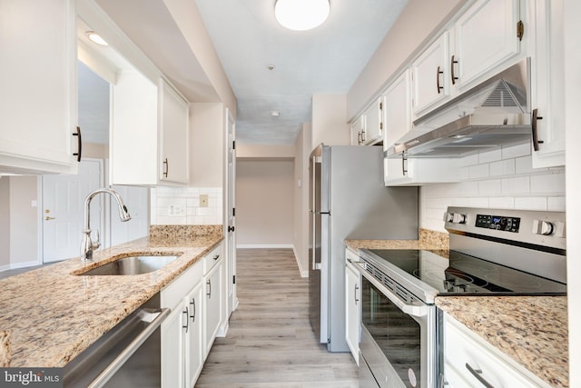 kitchen with sink, stainless steel appliances, white cabinets, and light stone countertops