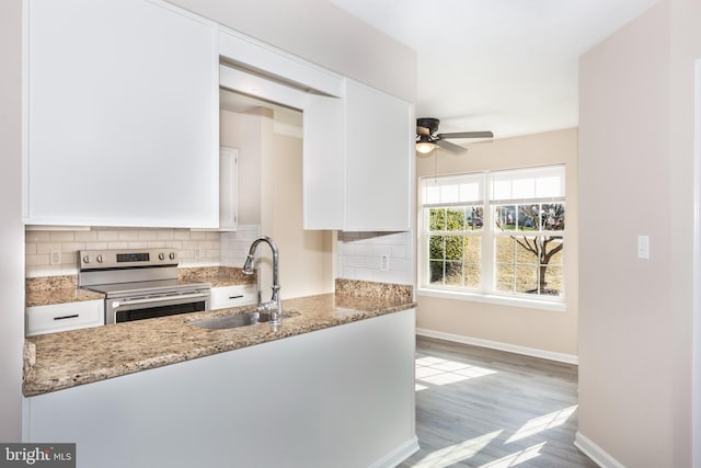 kitchen featuring white cabinetry, stone countertops, sink, and stainless steel range with electric cooktop