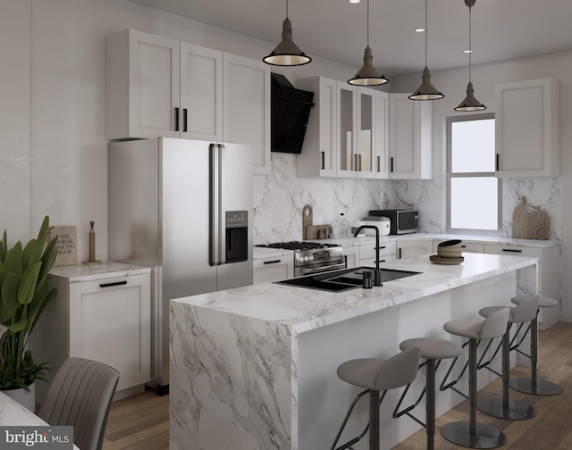 kitchen featuring light stone countertops, ventilation hood, hanging light fixtures, and white cabinets