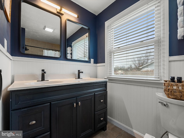 bathroom with vanity, walk in shower, and toilet