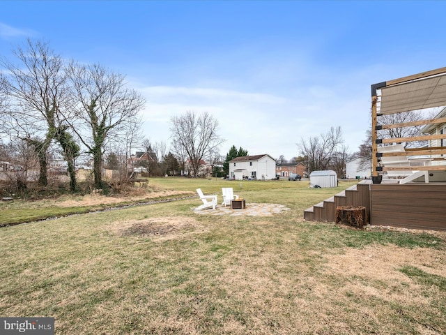 view of yard with a fire pit