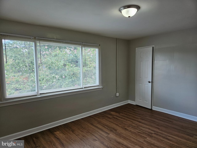 empty room with dark hardwood / wood-style floors