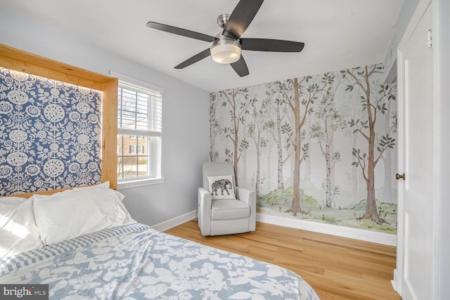 bedroom with hardwood / wood-style flooring and ceiling fan