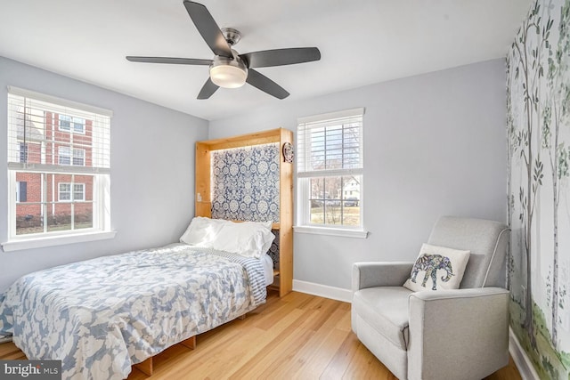 bedroom with ceiling fan and light hardwood / wood-style floors