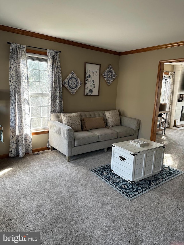 unfurnished living room with ornamental molding and light colored carpet