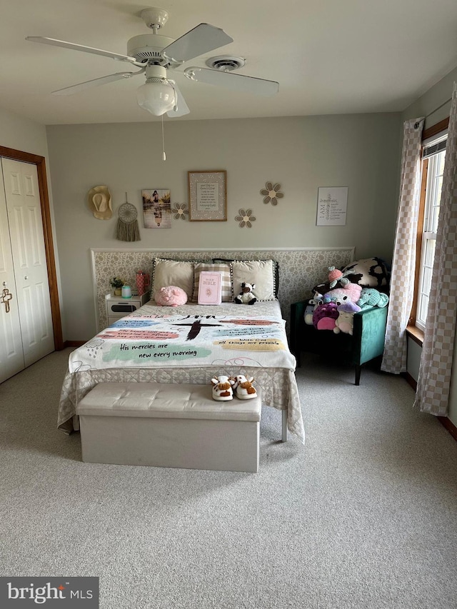 bedroom featuring ceiling fan and carpet