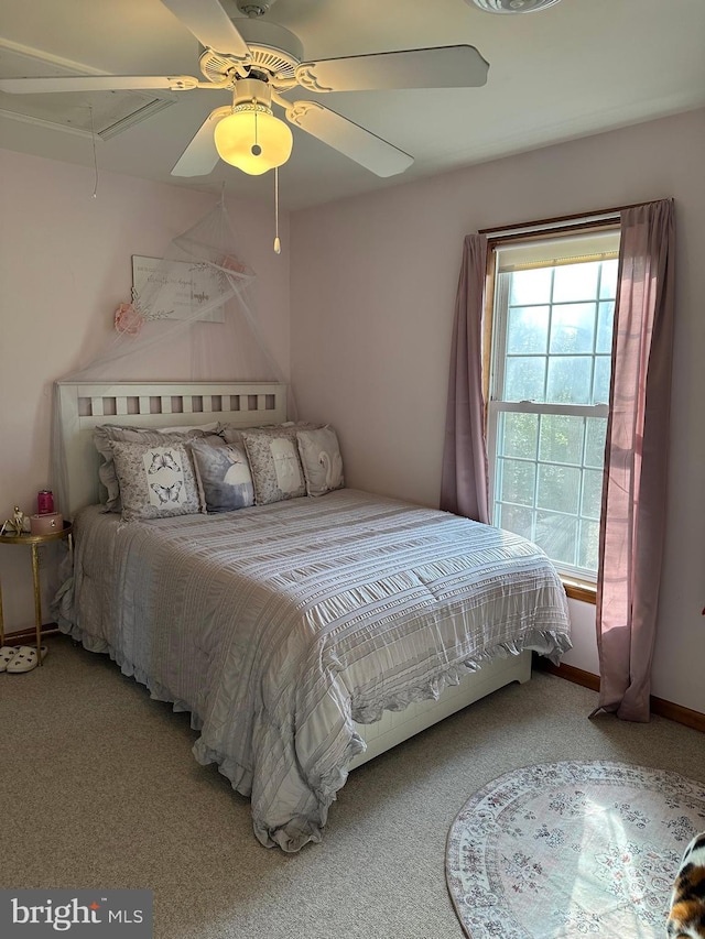 carpeted bedroom with ceiling fan and multiple windows