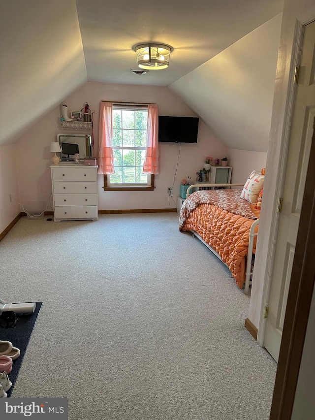 carpeted bedroom featuring lofted ceiling