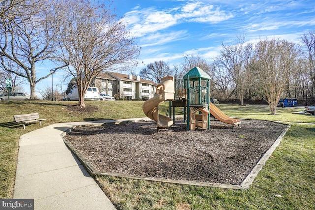 view of playground with a lawn