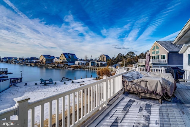 exterior space with a deck with water view and grilling area