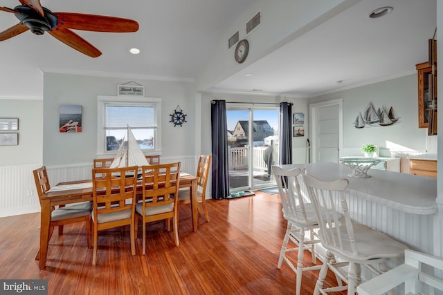 dining space featuring hardwood / wood-style flooring, ornamental molding, and ceiling fan