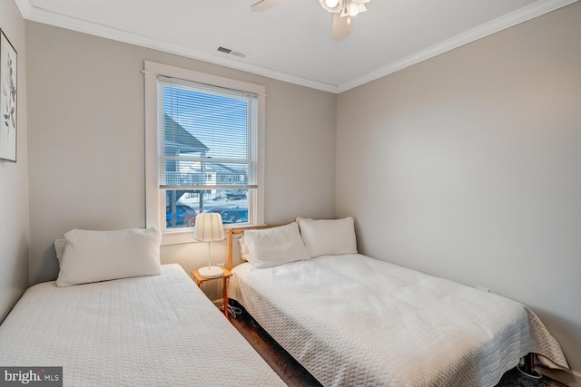 bedroom with ceiling fan, ornamental molding, and hardwood / wood-style floors