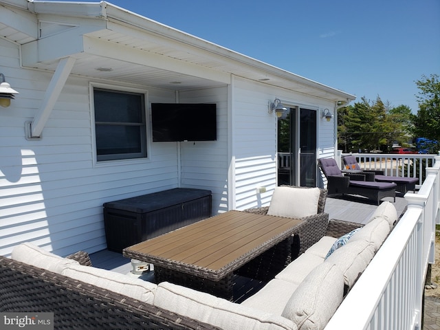 wooden terrace featuring an outdoor living space