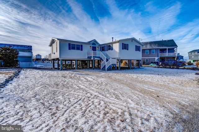 snow covered property with a carport