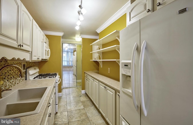 kitchen featuring sink, backsplash, light tile patterned floors, crown molding, and white appliances