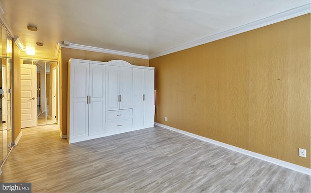 unfurnished bedroom with ornamental molding and light hardwood / wood-style floors