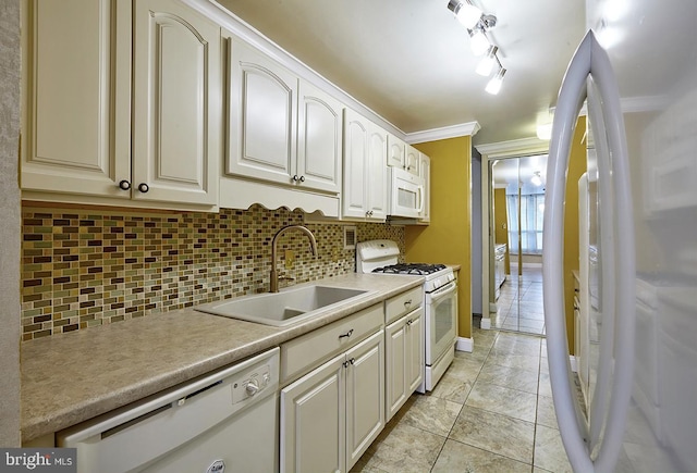 kitchen with sink, crown molding, white appliances, light tile patterned flooring, and decorative backsplash