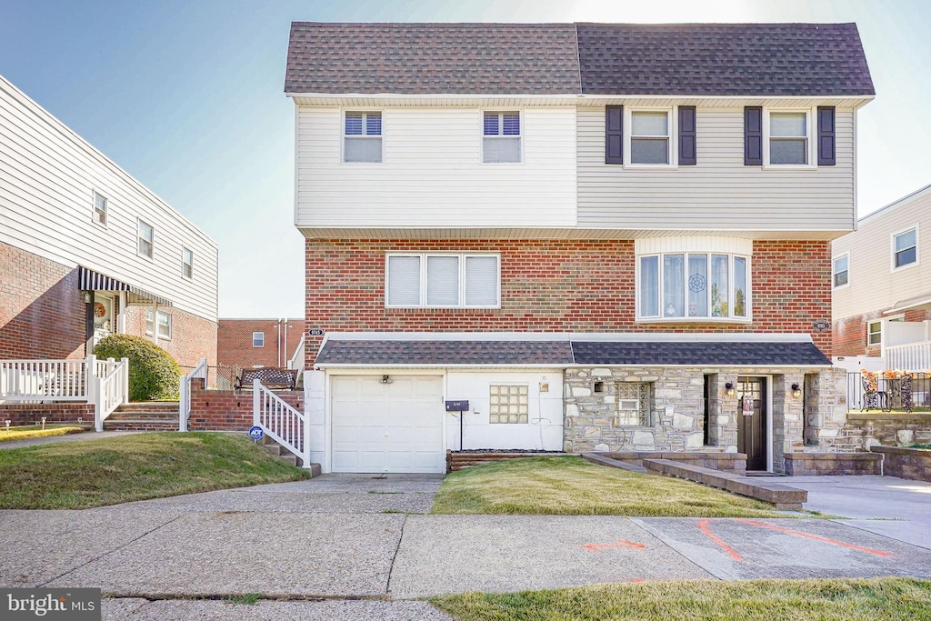 view of front of home with a garage and a front lawn