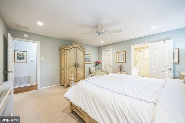 carpeted bedroom featuring ceiling fan and ensuite bathroom