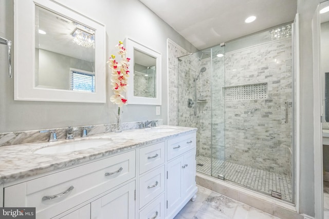 bathroom with walk in shower and vanity