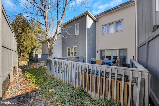 rear view of house featuring a wooden deck