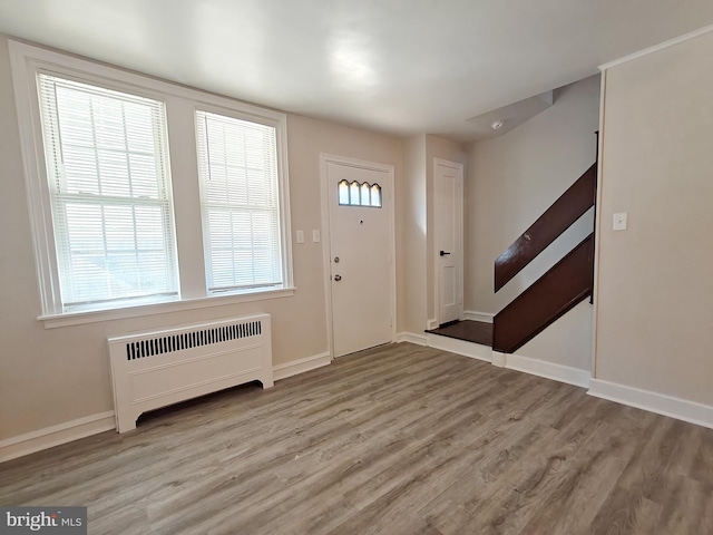 entryway with radiator and light hardwood / wood-style floors