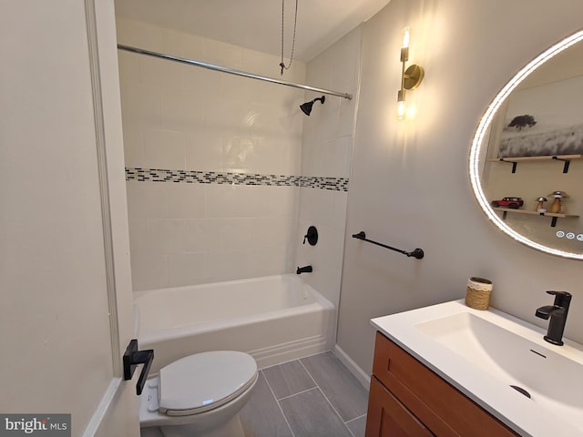 full bathroom with tiled shower / bath combo, vanity, and toilet