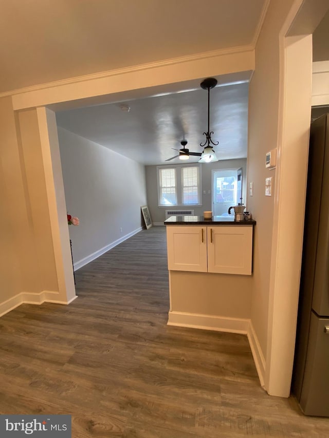 kitchen featuring pendant lighting, ceiling fan, fridge, white cabinets, and dark hardwood / wood-style flooring