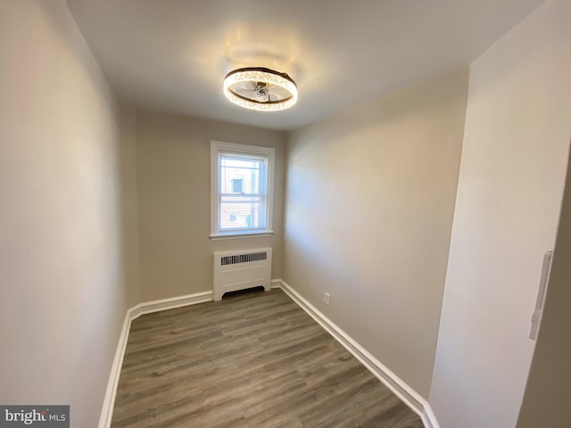 interior space featuring dark wood-type flooring and radiator heating unit