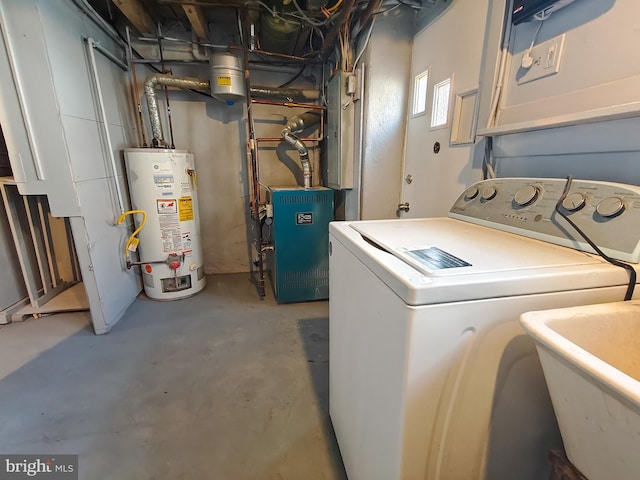 clothes washing area featuring washer / clothes dryer, sink, and gas water heater