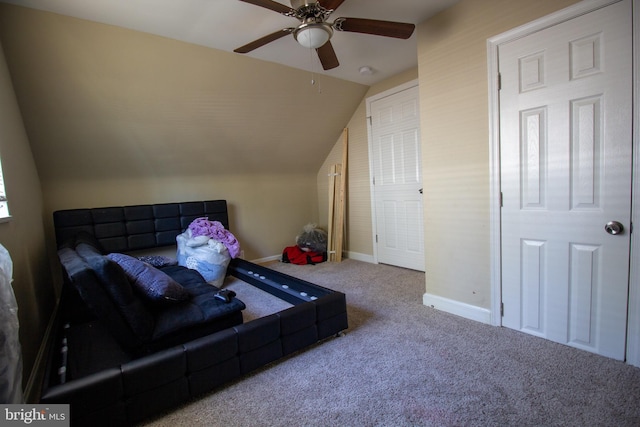 carpeted living room featuring vaulted ceiling and ceiling fan