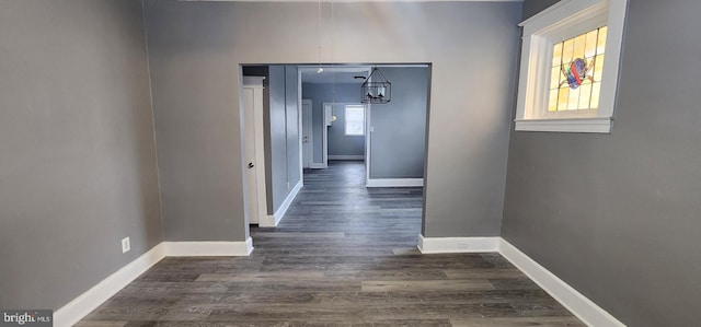 hallway with dark hardwood / wood-style flooring