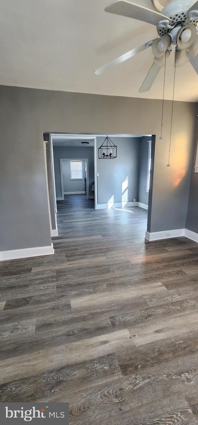 interior space with ceiling fan and dark hardwood / wood-style flooring