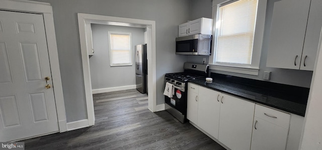 kitchen featuring white cabinetry, dark wood-type flooring, and stainless steel appliances