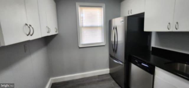 kitchen with white cabinets and appliances with stainless steel finishes