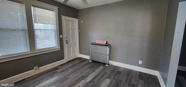 entrance foyer with radiator heating unit, dark hardwood / wood-style floors, and ceiling fan