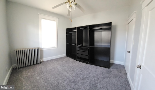 unfurnished bedroom with radiator, ceiling fan, and carpet