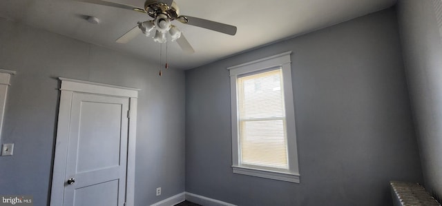 spare room featuring ceiling fan and radiator