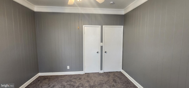 carpeted spare room with crown molding and ceiling fan