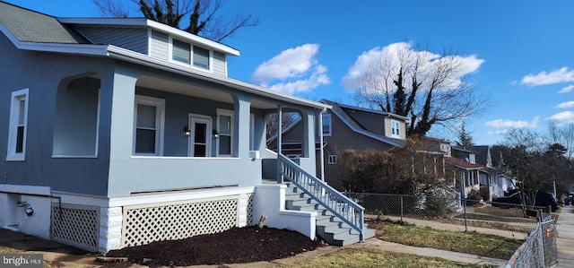 view of side of property featuring covered porch