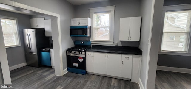 kitchen featuring stainless steel appliances, white cabinetry, and dark hardwood / wood-style flooring