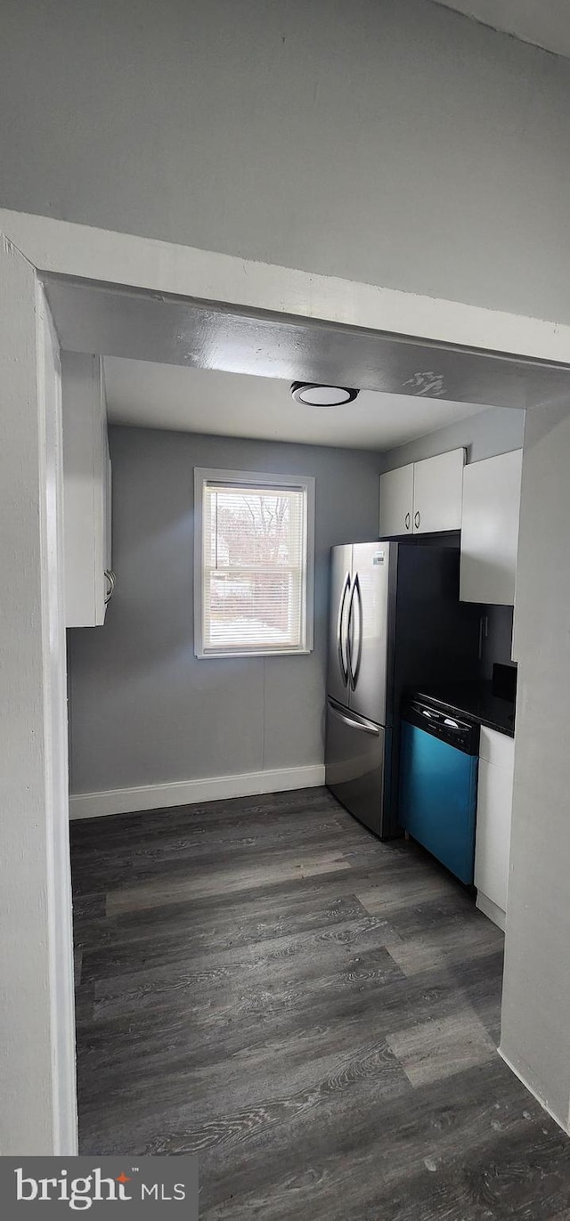 kitchen with dark hardwood / wood-style flooring, stainless steel appliances, and white cabinets