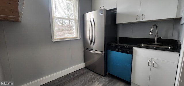 kitchen with dark wood-type flooring, sink, stainless steel refrigerator, dishwasher, and white cabinets